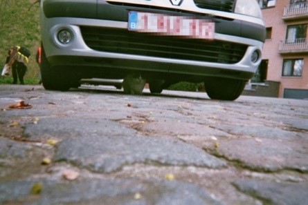 picture of a cat under a car